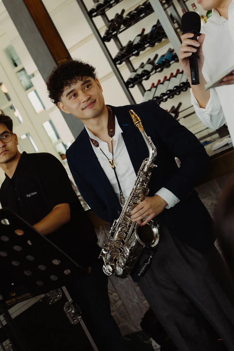 Danial holding his saxophone at a wedding performance